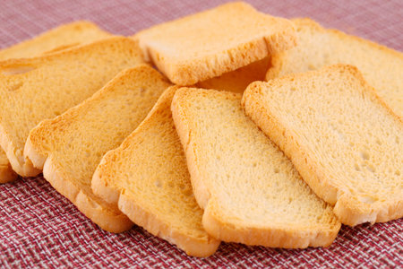 Rusks  isolated on colorful tablecloth.