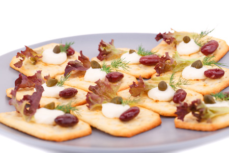 Crackers with red kidney beans and cream on gray plate.の写真素材