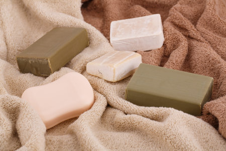 Colorful towels and soaps closeup picture.