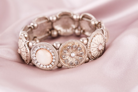 Stylish bracelet with stones on fabric background.の写真素材