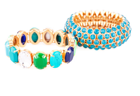 Stylish bracelets with colorful stones isolated on white background.