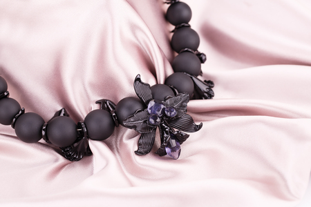 Beautiful pendant on pink fabric background.の写真素材