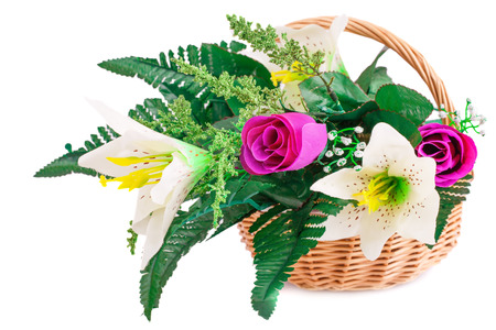 Colorful fabric flowers in wicker basket isolated on white background.の写真素材