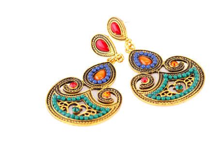 Ancient style earrings with colorful stones isolated on white background.の写真素材