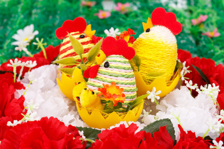 Easter setting with hens, chickens and eggs on flowers nest.の写真素材