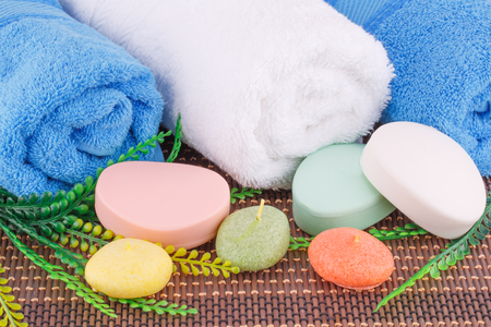 White and blue towels with soaps,  candles and leaves closeup picture.の写真素材