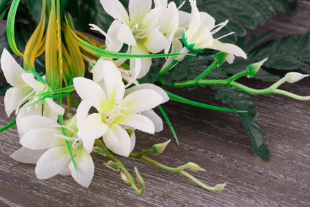 White artificial flowers on wooden background, closeup picture.の写真素材