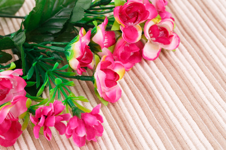 Pink fabric flowers on cloth background, closeup picture.の写真素材