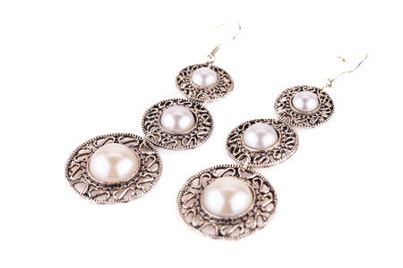 Ancient style earrings isolated on white background.の写真素材