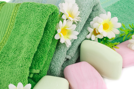 Folded towels, soaps and flowers closeup picture.の写真素材