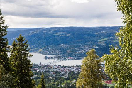 Landscape with mountains, river and buildings in Lillehammer town, Norway.
