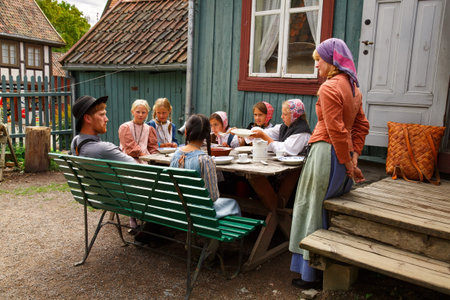 Oslo, Norway-August 13, 2014 - People in national costumes presents a family having breakfast at...