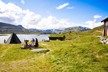 Norway-August 15, 2014 -  Landscape with mountain, lake, houses and people in Norwegian rural place.のeditorial素材
