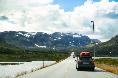 Norway-August 15, 2014 -  Road with cars in Norwegian rural place.のeditorial素材