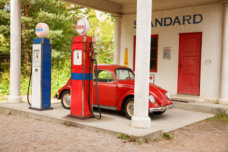 Oslo, Norway-August 13, 2014 - Norwegian Museum of Cultural History. Standard Oil gas station of 1928 relocated from Holmestrand and vintage car at Norsk Folkemuseum.のeditorial素材