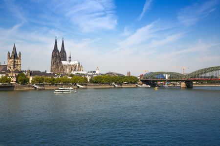 Roman Catholic Gothic Cathedral, Great St. Martin church, main train station and  Hohenzollern Bridge in Germany, view from the other side of Rhine river.の写真素材