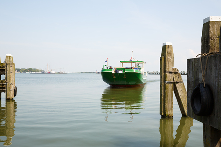 Enkhuizen, Netherlands - August 19, 2015 - The boat with passengers at the harbour.のeditorial素材