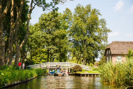 Giethoorn, Netherlands, August 20, 2015 - The unknown tourists on the sightseeing boats in the Dutch fairytale village.のeditorial素材