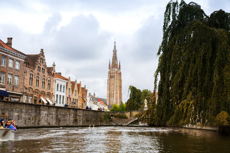 Bruges, Belgium-August 15, 2015- The Church of Our Lady and the medieval houses at the canal in Brugge.のeditorial素材