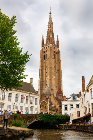 Bruges, Belgium-August 15, 2015-The Church of Our Lady and the medieval houses at the canal in Brugge.のeditorial素材
