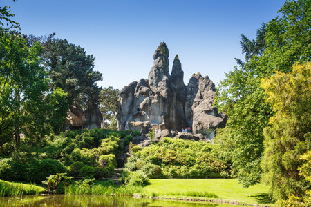 Hamburg, Germany - June 5, 2016 -Landscape with rock, lake, people and trees  in the Hagenbeck zoo.のeditorial素材