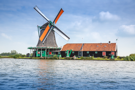Traditional, authentic dutch windmill at the river Zaam in Zaanse Schans village.のeditorial素材