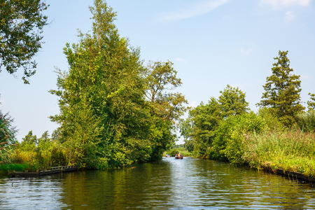 Giethoorn, Netherlands, August 20, 2015 - The unknown tourists on the sightseeing boats in the Dutch fairytale village.のeditorial素材