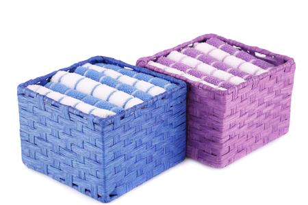 Pink, blue and white folded towels in boxes isolated on white background.の写真素材