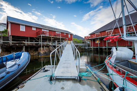 The view of the fisherman village Sorvagen with typical rorbu houses and boats in Lofoten islands, Norway.のeditorial素材