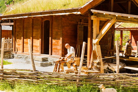 Gudvangen, Norway - June 13 - Traditional wooden houses and people in national clothes in the viking village museum.のeditorial素材