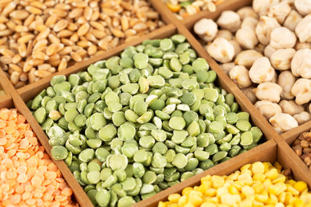 The collection of different groats, lentils, wheat, chickpea and peas in the wooden box.