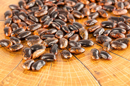 Scarlet runner beans on brown background.