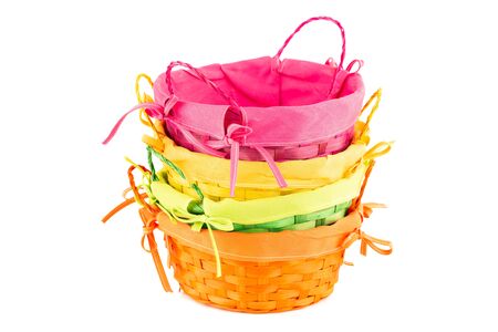 Stack of four colorful empty wicker baskets isolated on white background.の写真素材