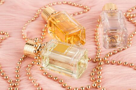 Limassol, Cyprus - August 1, 2019 - Three bottles of Ex Nihilo perfume and beads on pink fur background. Fleur Narcotique, Venenum Kiss, Viper Green.のeditorial素材