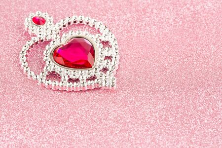 Jewelry heart with stones on pink sparkling background.の写真素材