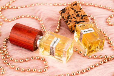 Limassol, Cyprus - August 1, 2019 - Two bottles of Nasomatto perfume Nudiflorum and  Baraonda with beads on pink fur background.のeditorial素材