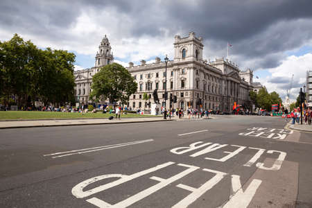 London, UK - August 8, 2019 - The Department for Digital, Culture, Media and Sport, Sir Winston Churchill Statue on Parliament street. Tourists sitting in storied square with statues of leaders in Westminster district.のeditorial素材