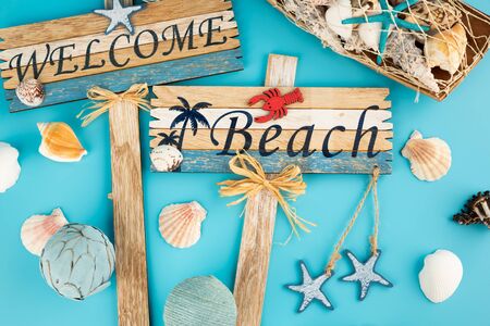 Wooden signs welcome beach and shells on blue background.の写真素材