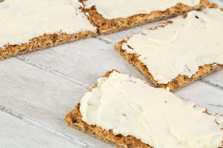 Sandwiches with butter on gray wooden background.