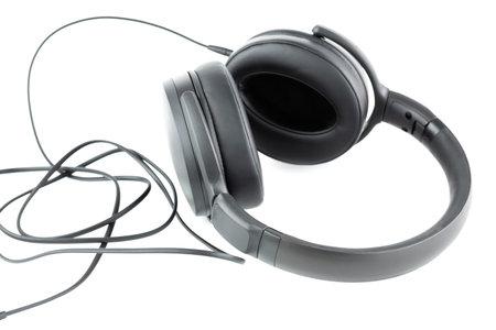 Black headphone with cable isolated on white background.の写真素材