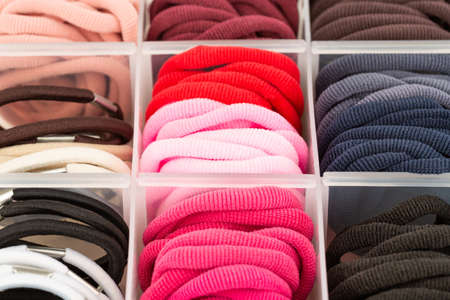 The assortment of colorful elastic hair bands in plastic box.の写真素材