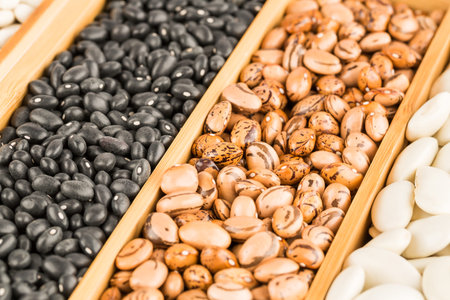 Different beans in the wooden box.