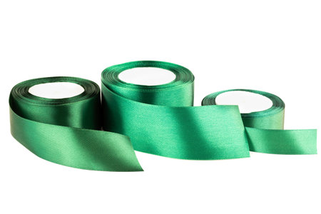 Green silk ribbon reels isolated on white background.の写真素材