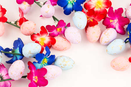 Easter colorful eggs and flowers on white background.の写真素材