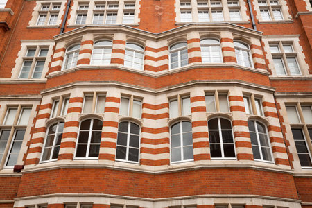 Old beautiful building in London, United Kingdom. Red bricks, white windows and ornaments.
