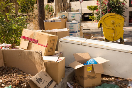 Limassol, Cyprus - October 24, 2020 - Different type of garbage and the old fridge in the city street.のeditorial素材