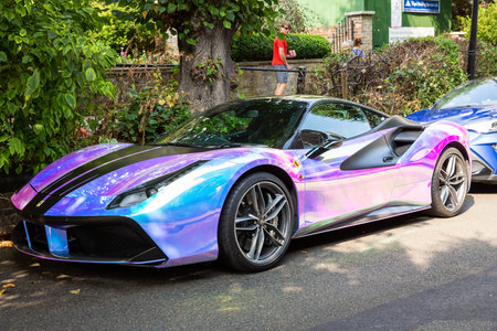 London, United Kingdom - September 5, 2021 - Purple Ferrari car parked in beautiful neighborhood....
