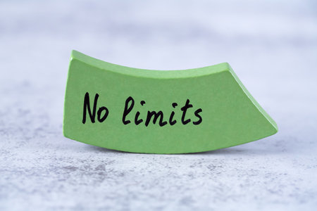 No limits words on the green wooden board on the gray background. No limits as a motivation for success.の写真素材