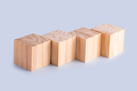 Four wooden cubes isolated on blue background. Four cubes with beautiful pattern on blue.
