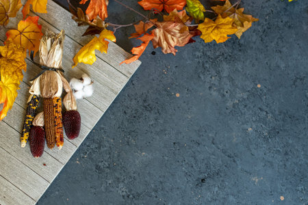 Autum Background with leaves, pumpkins, dried corn, and grourds.